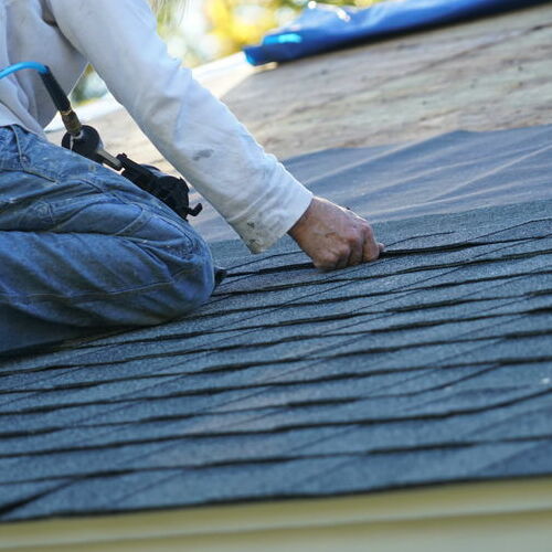 A roofer makes repairs.