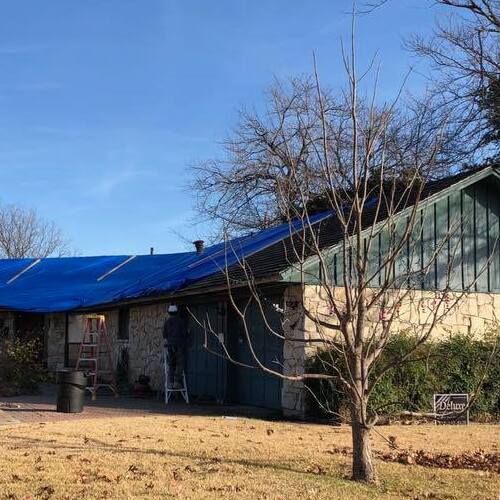 A roof tarped after storm damage