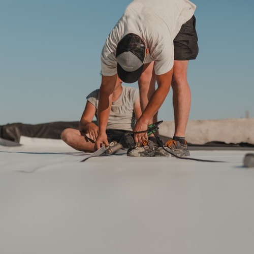 Roofer makes a commercial roof repair