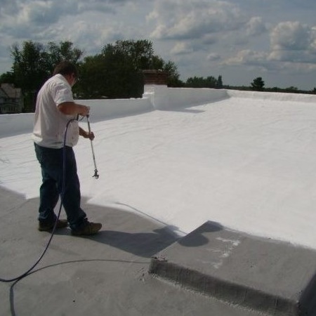 Roofer applies roof coating.
