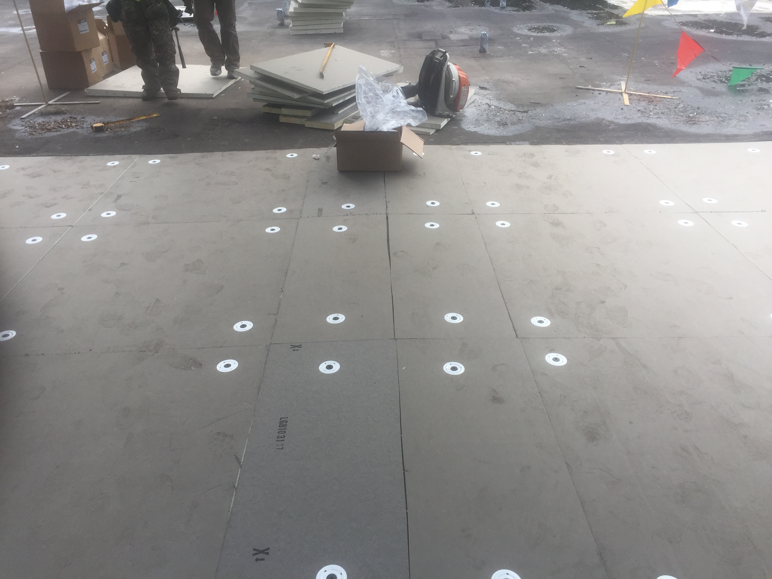 Roofer installs single ply roofing